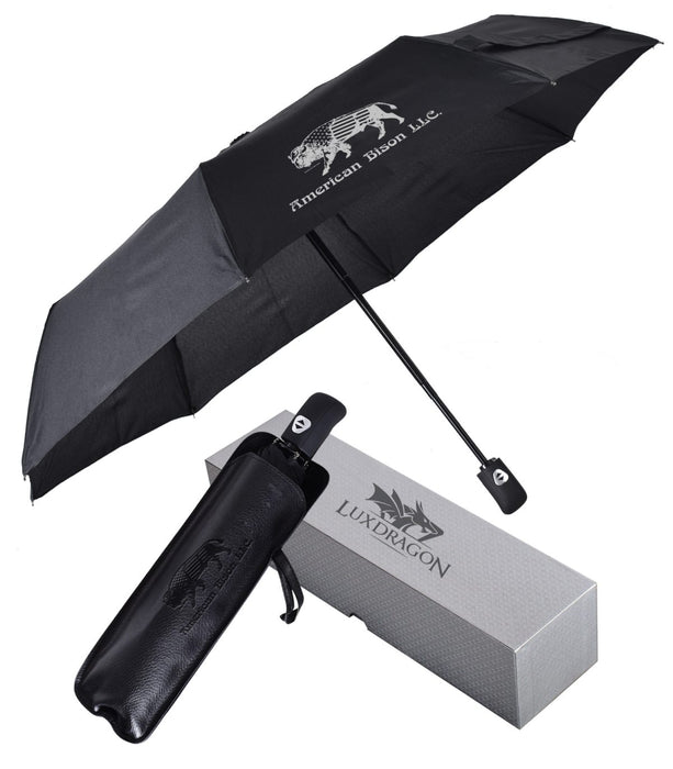 A black Peerless - Luxe 42 inch automatic open/close umbrella with a silver gift box, displayed next to its packaging box